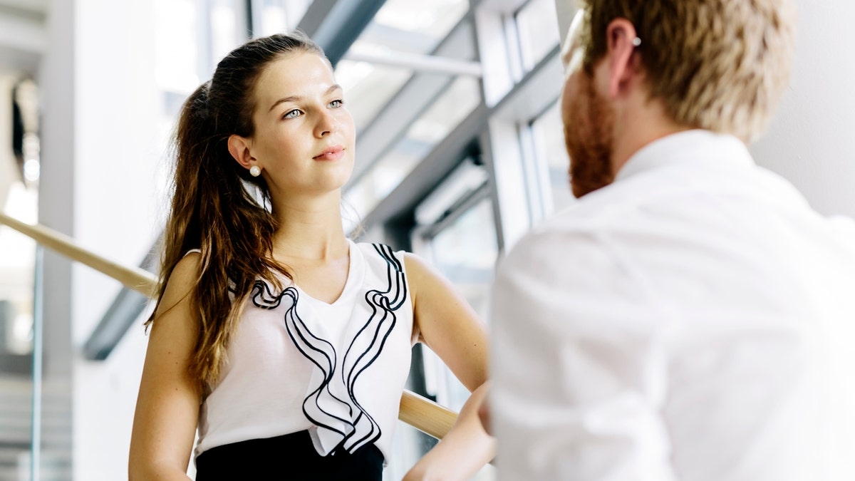 Two coworkers talking