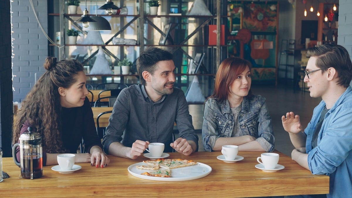 Friends talking at a cafe