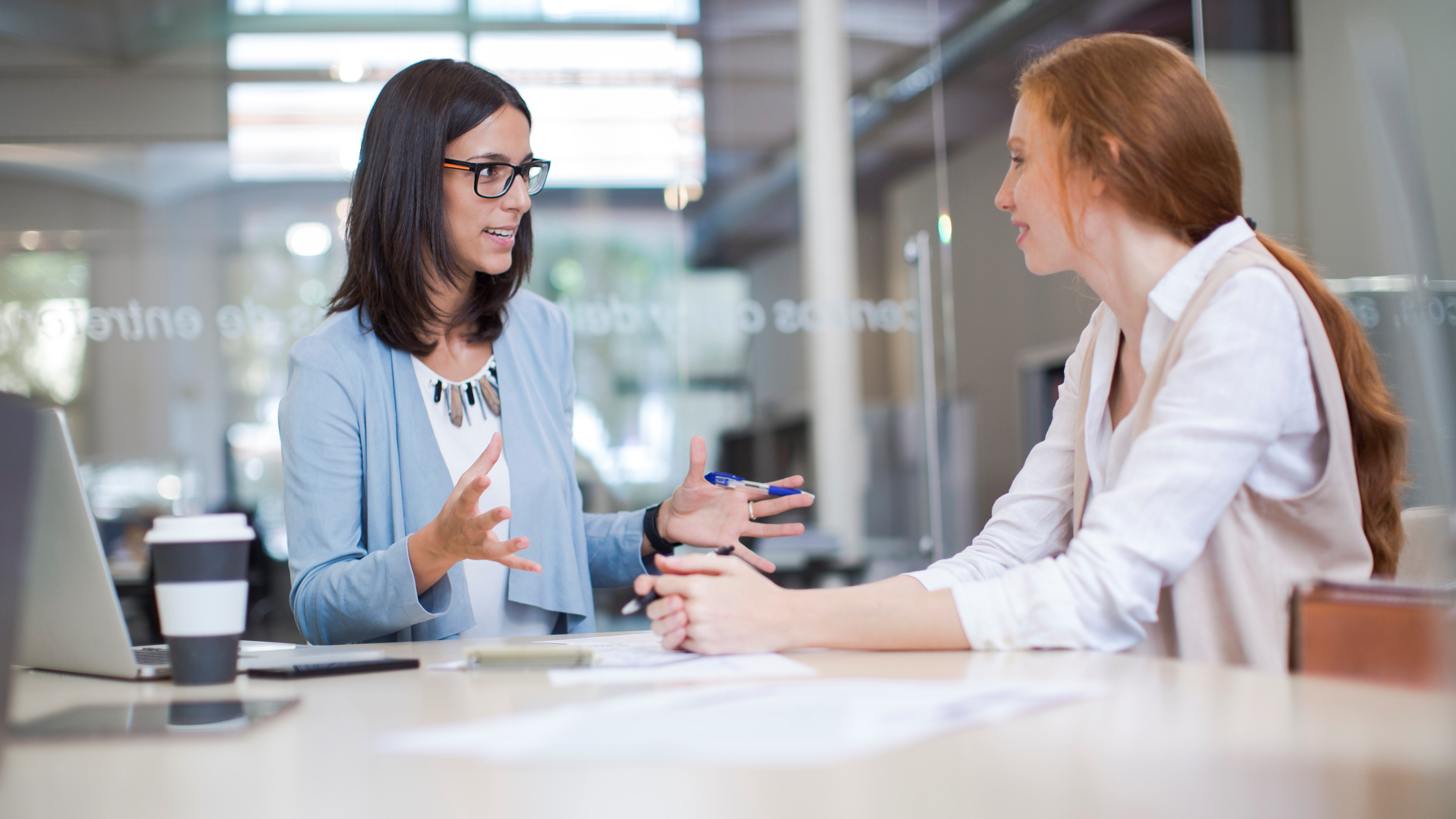 Two coworkers talking