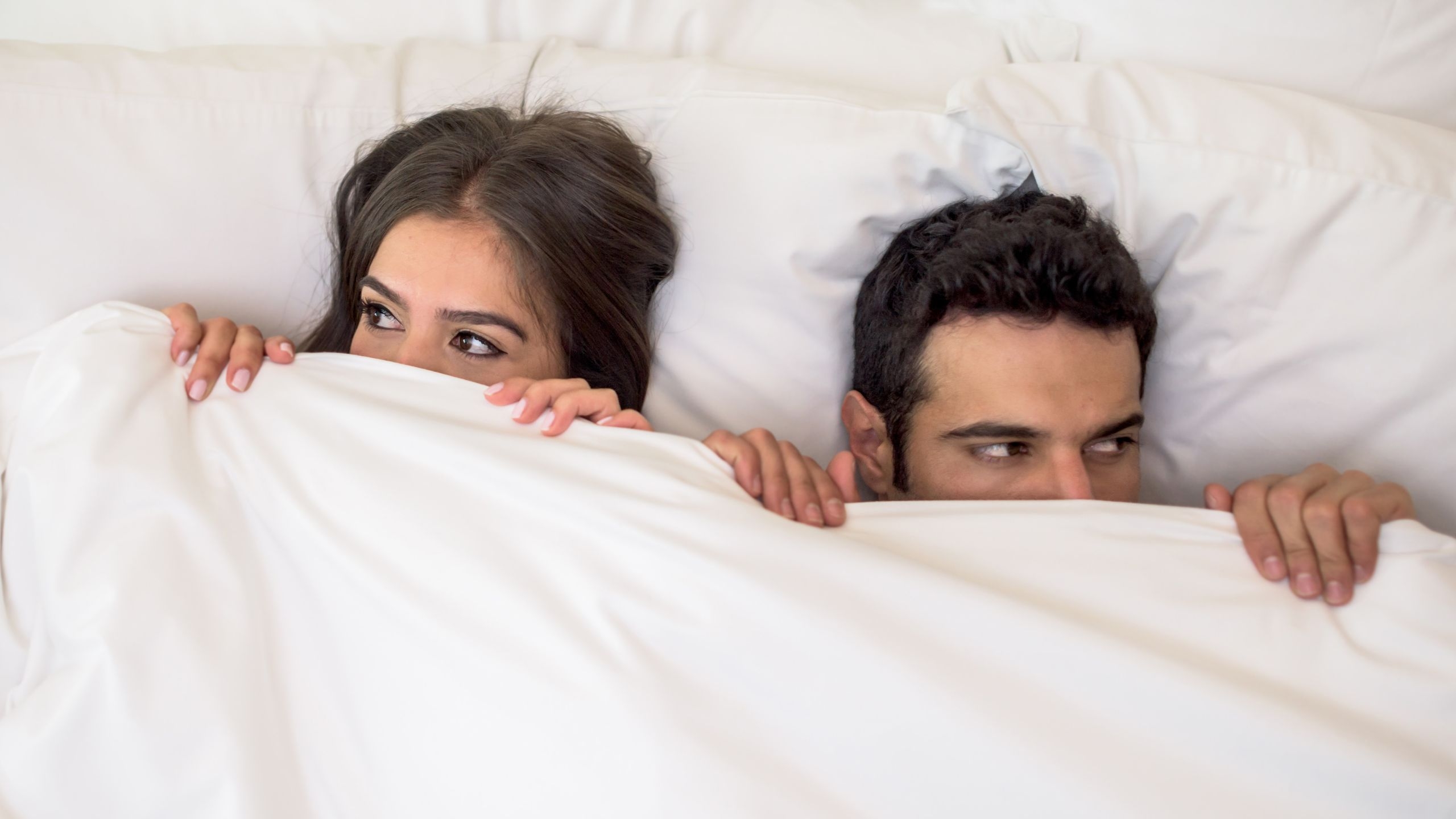 Worried couple in bed