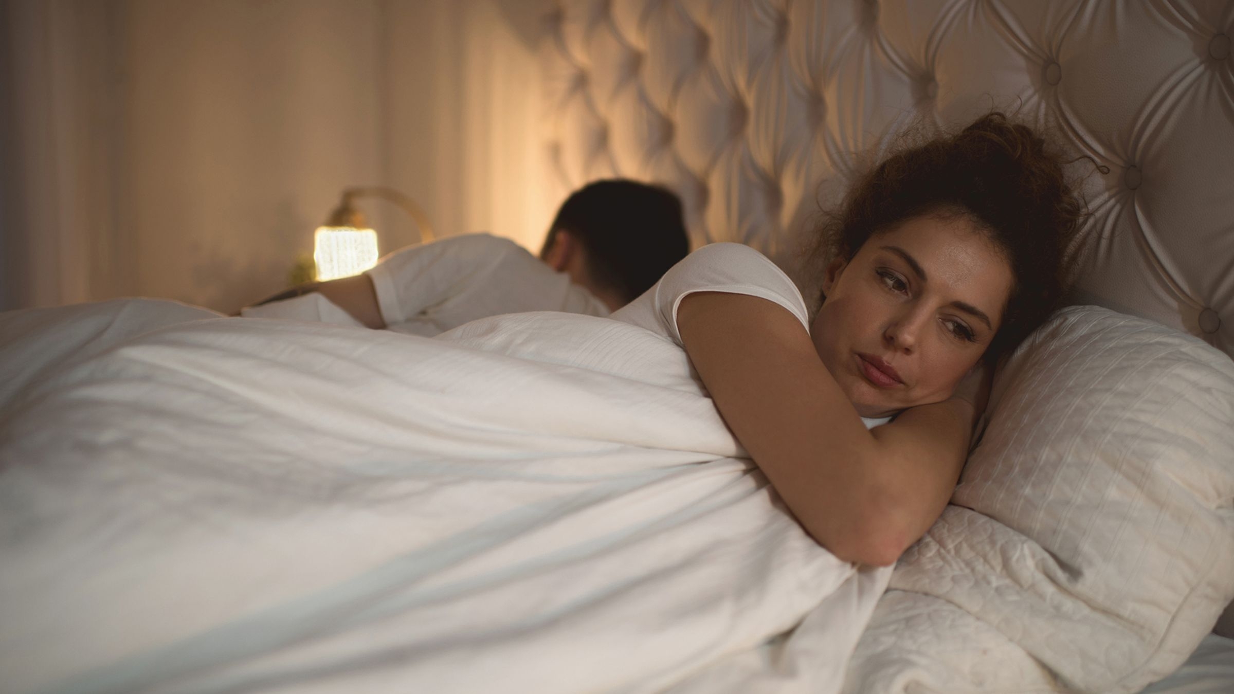 Sad woman in bed