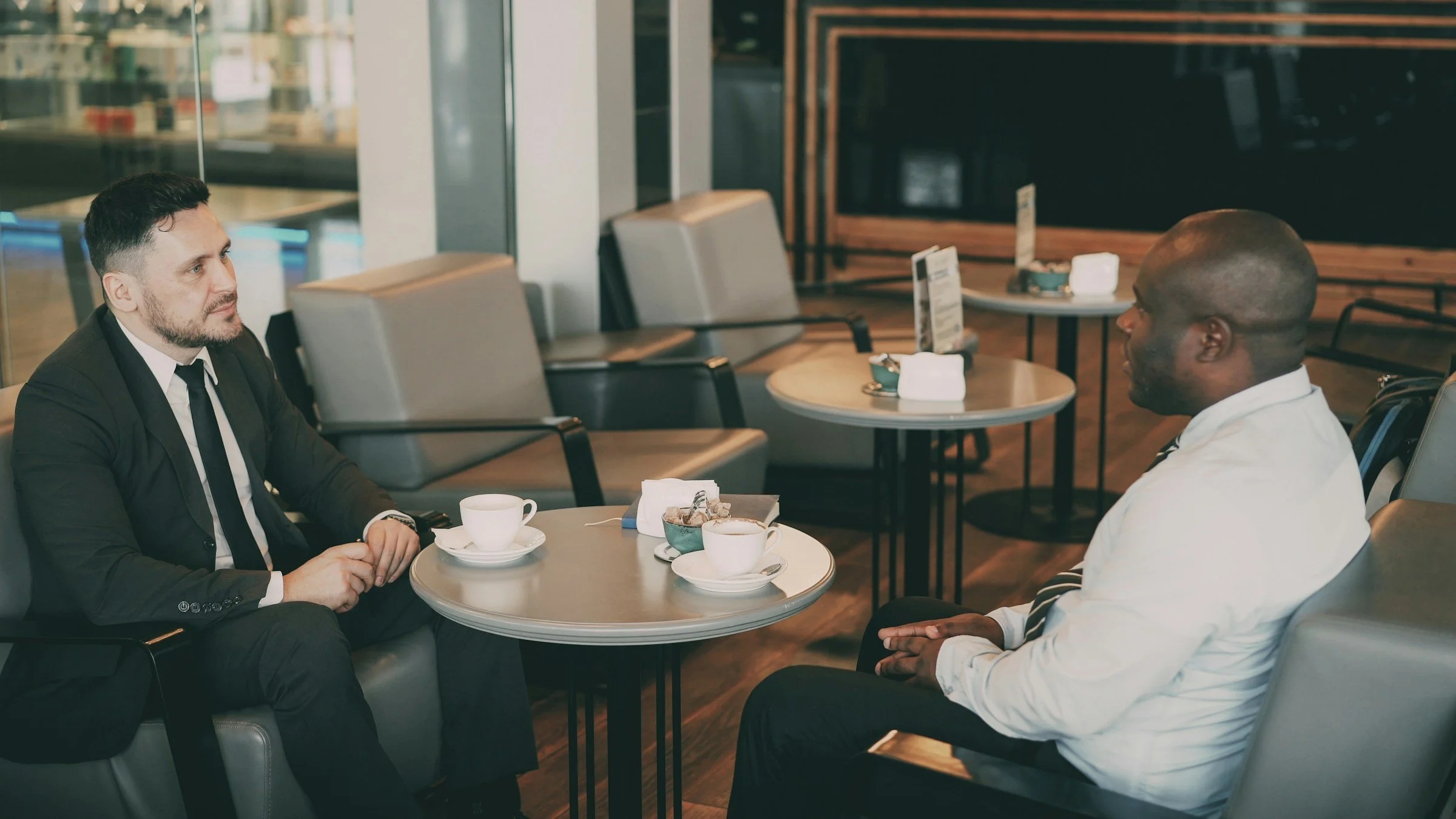Two friends talking in cozy cafe