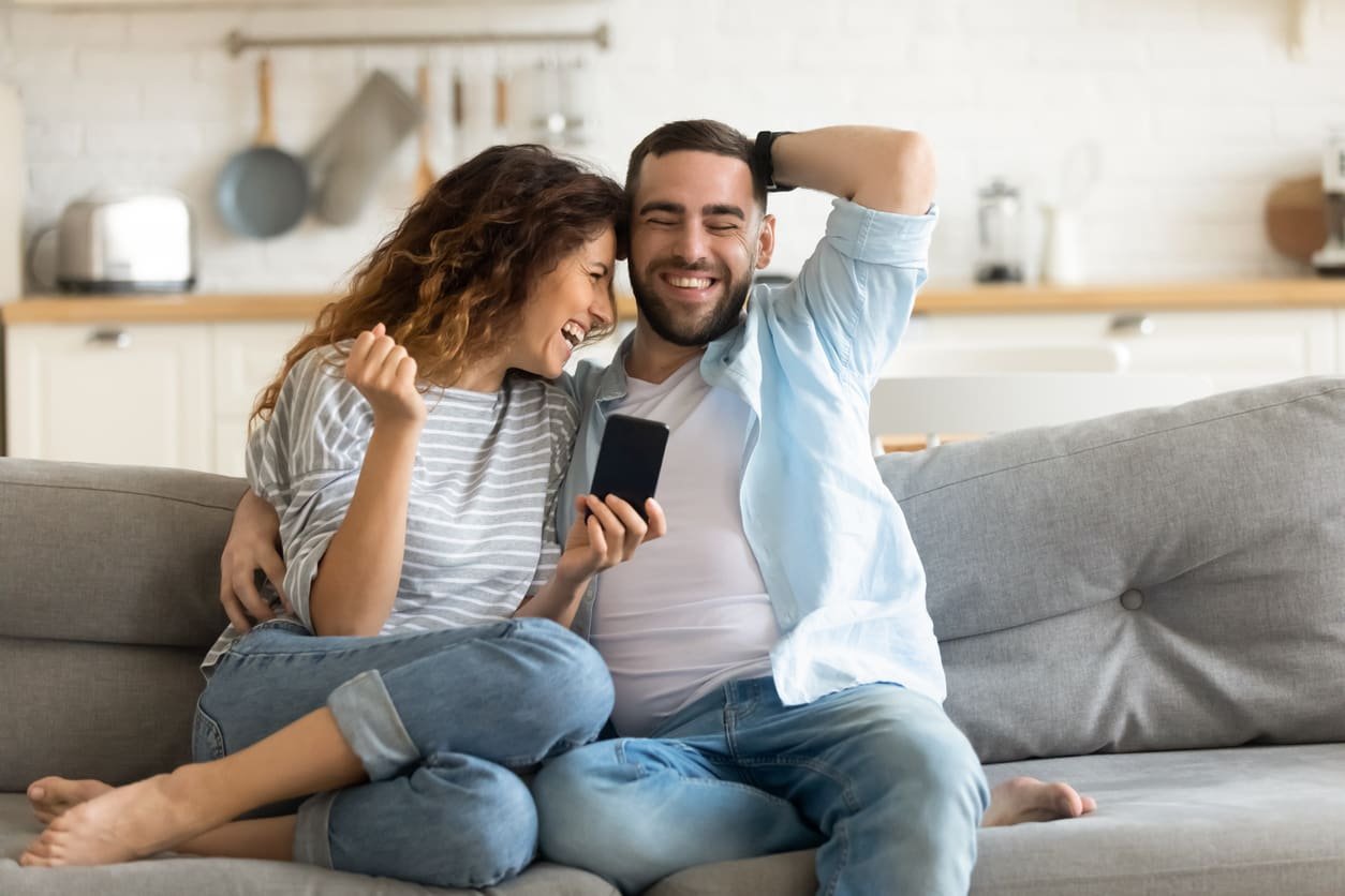 Couple joking on couch