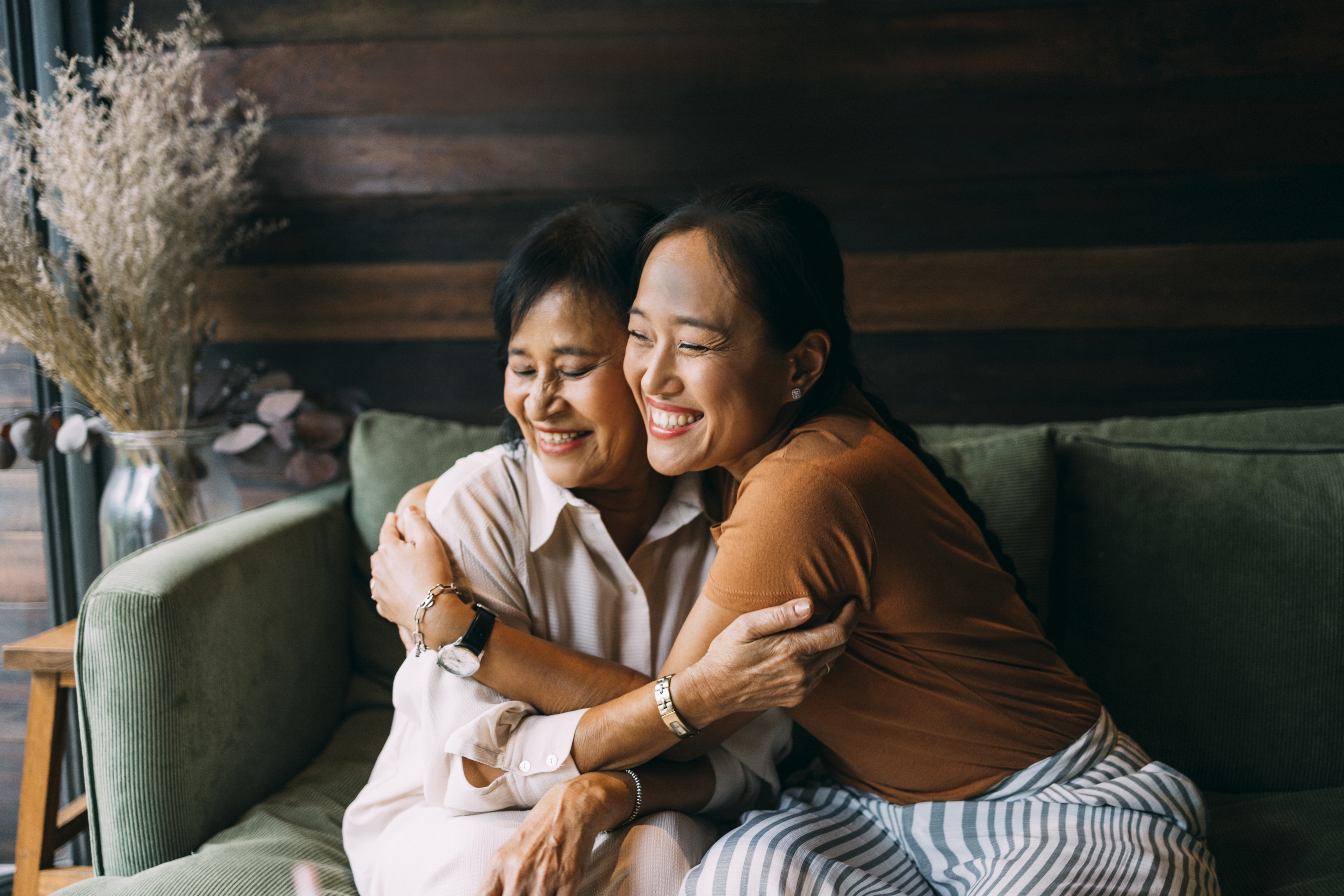 Friend comforting another on a couch