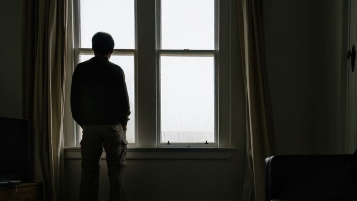 Man staring window