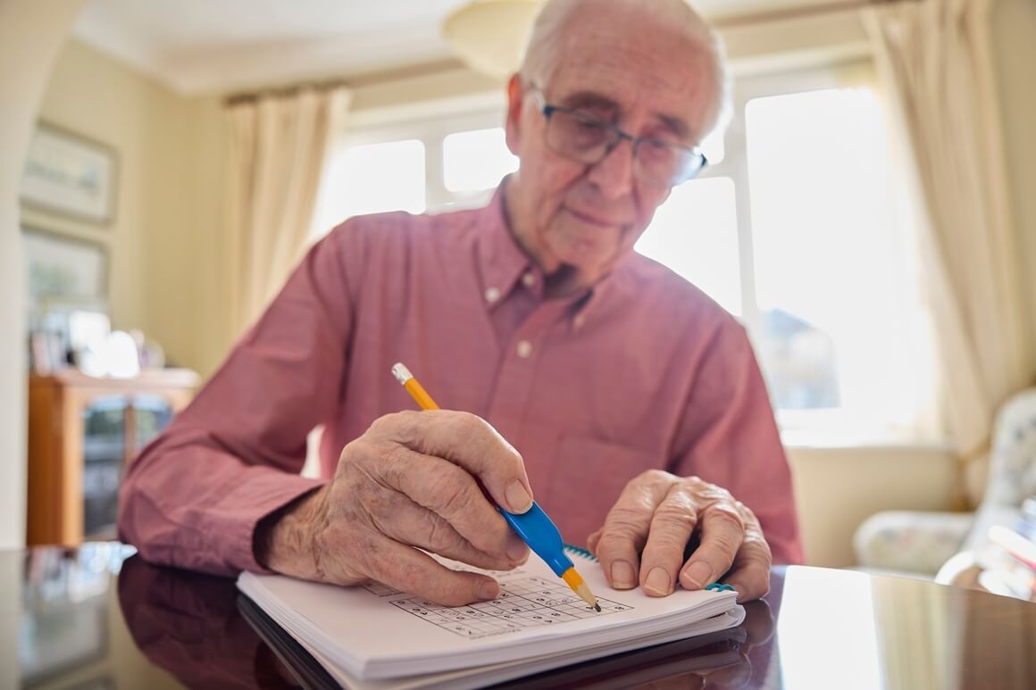 Older person writing in planner