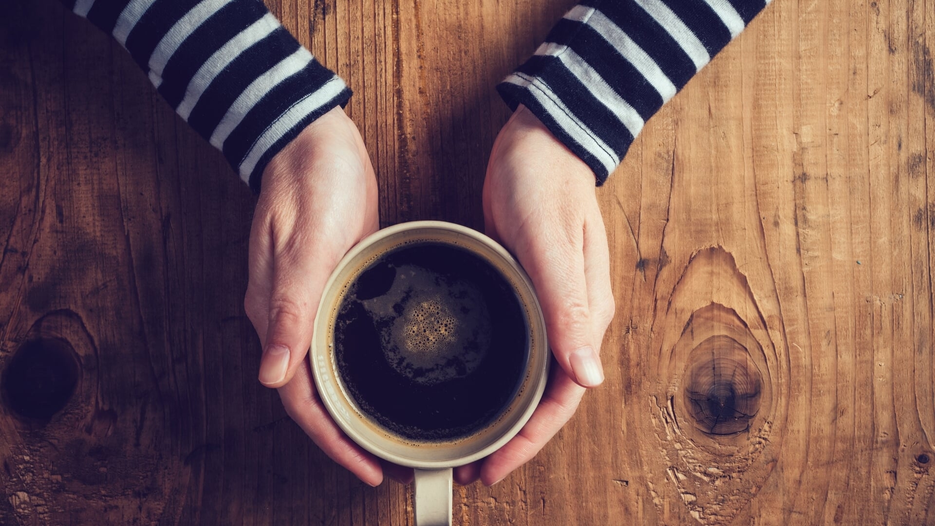 Person drinking black coffee