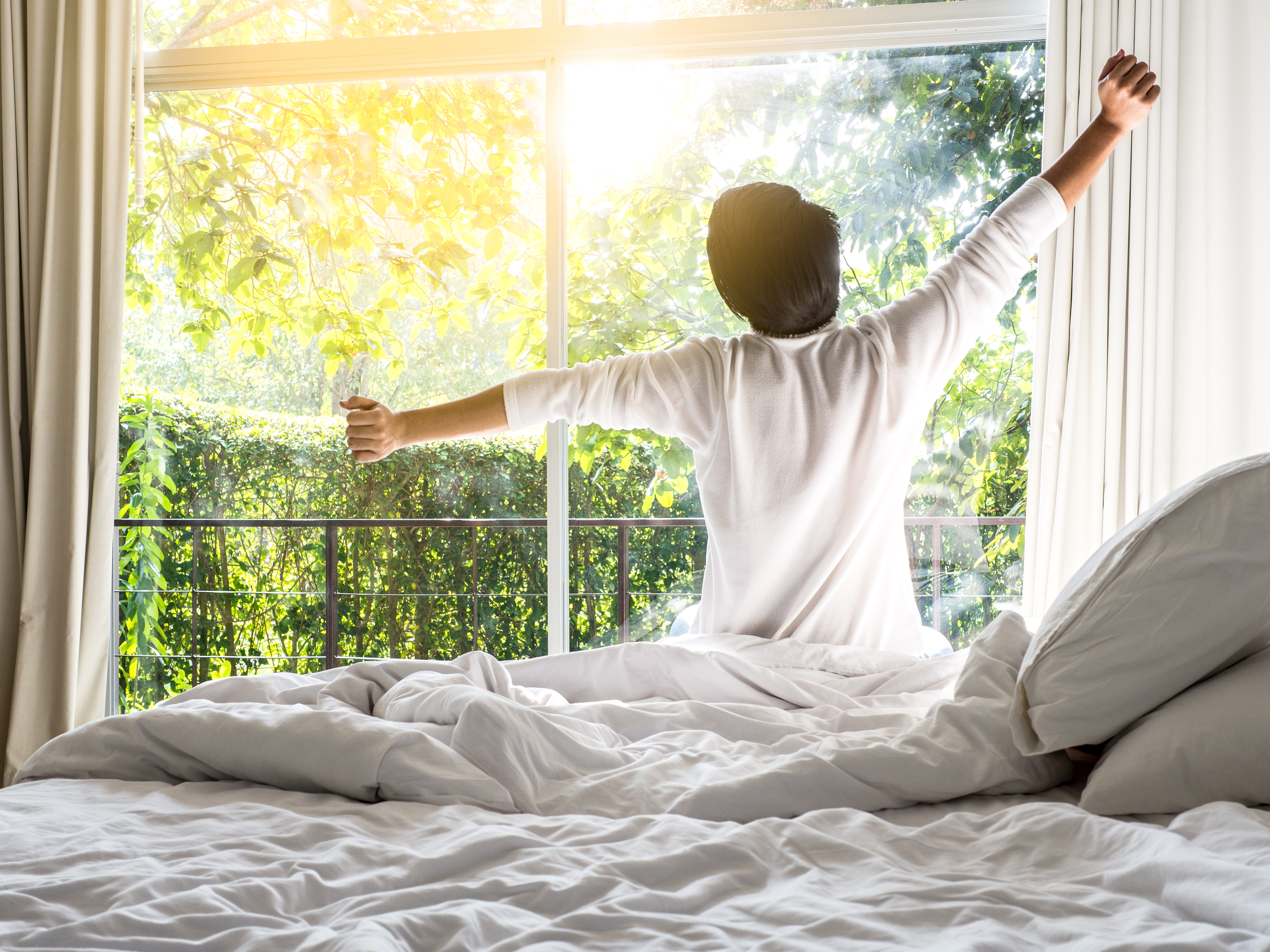 Person entering cozy bedroom