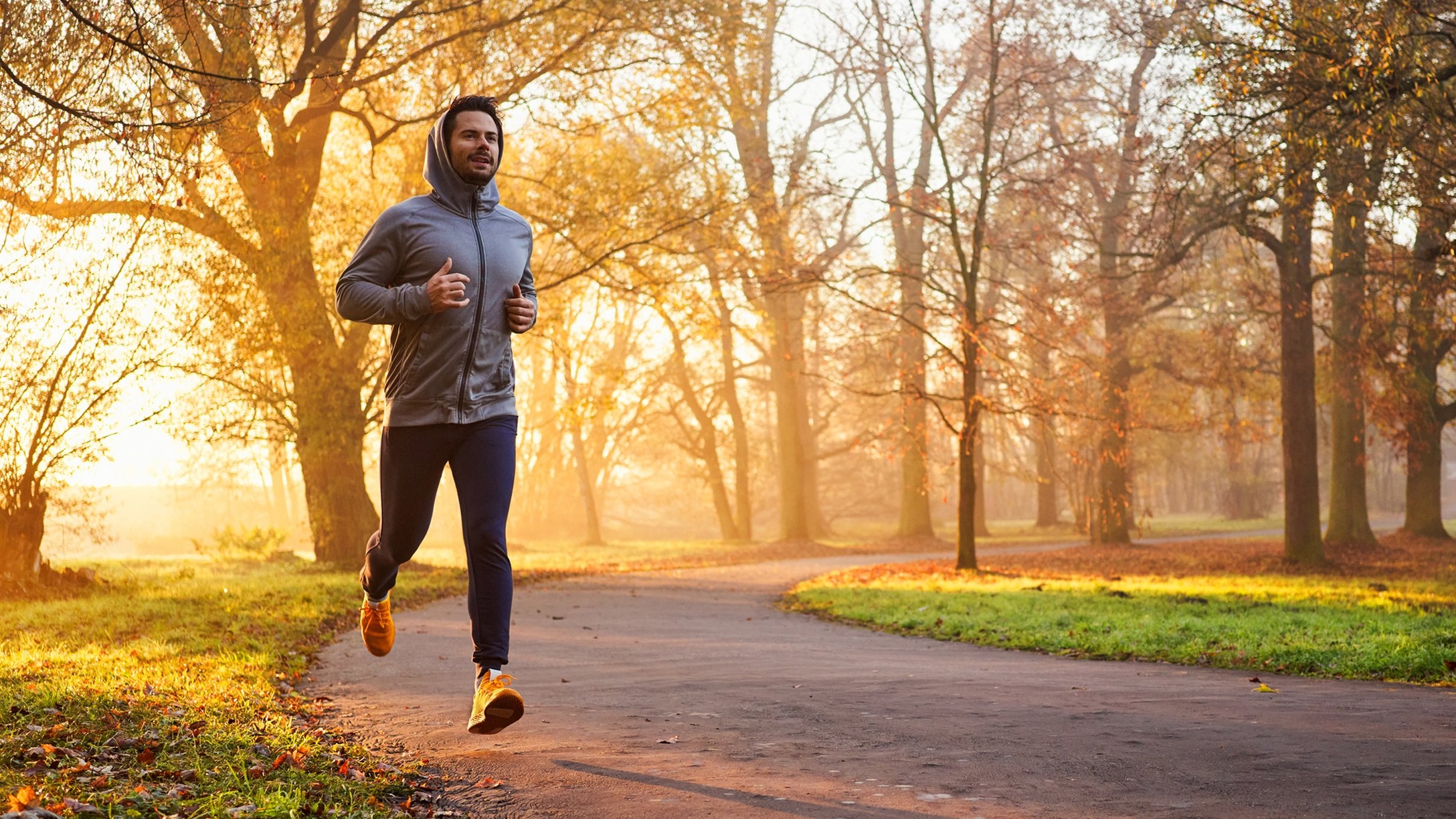 Person jogging at sunrise