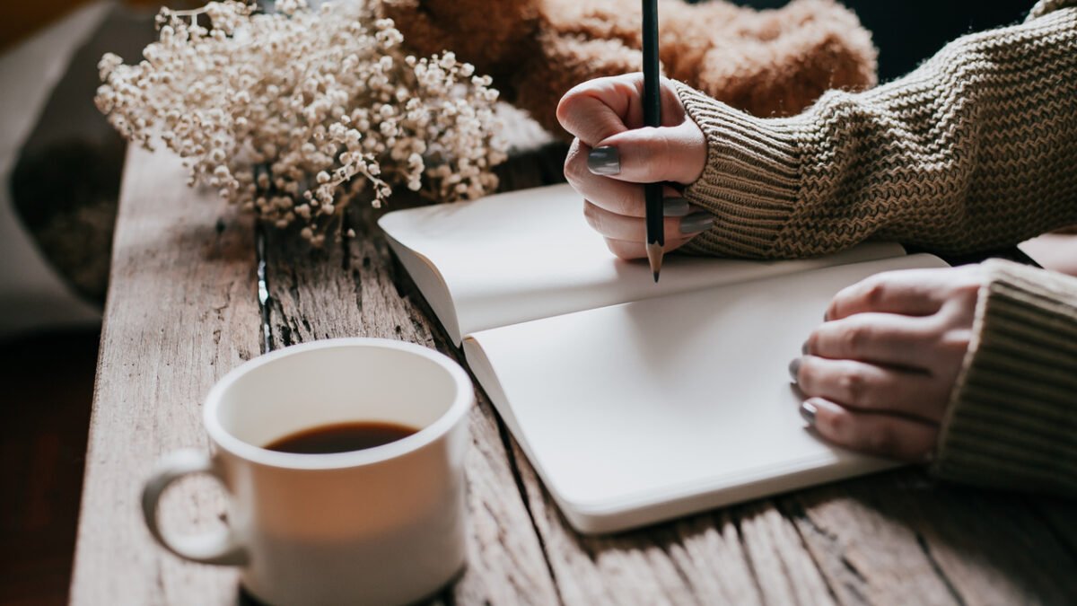 Person journaling tea