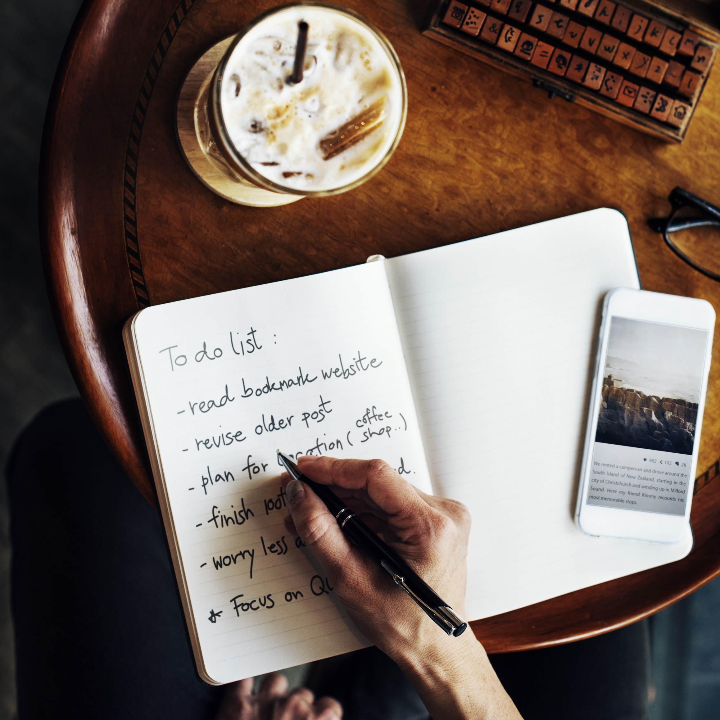Person journaling with coffee in morning