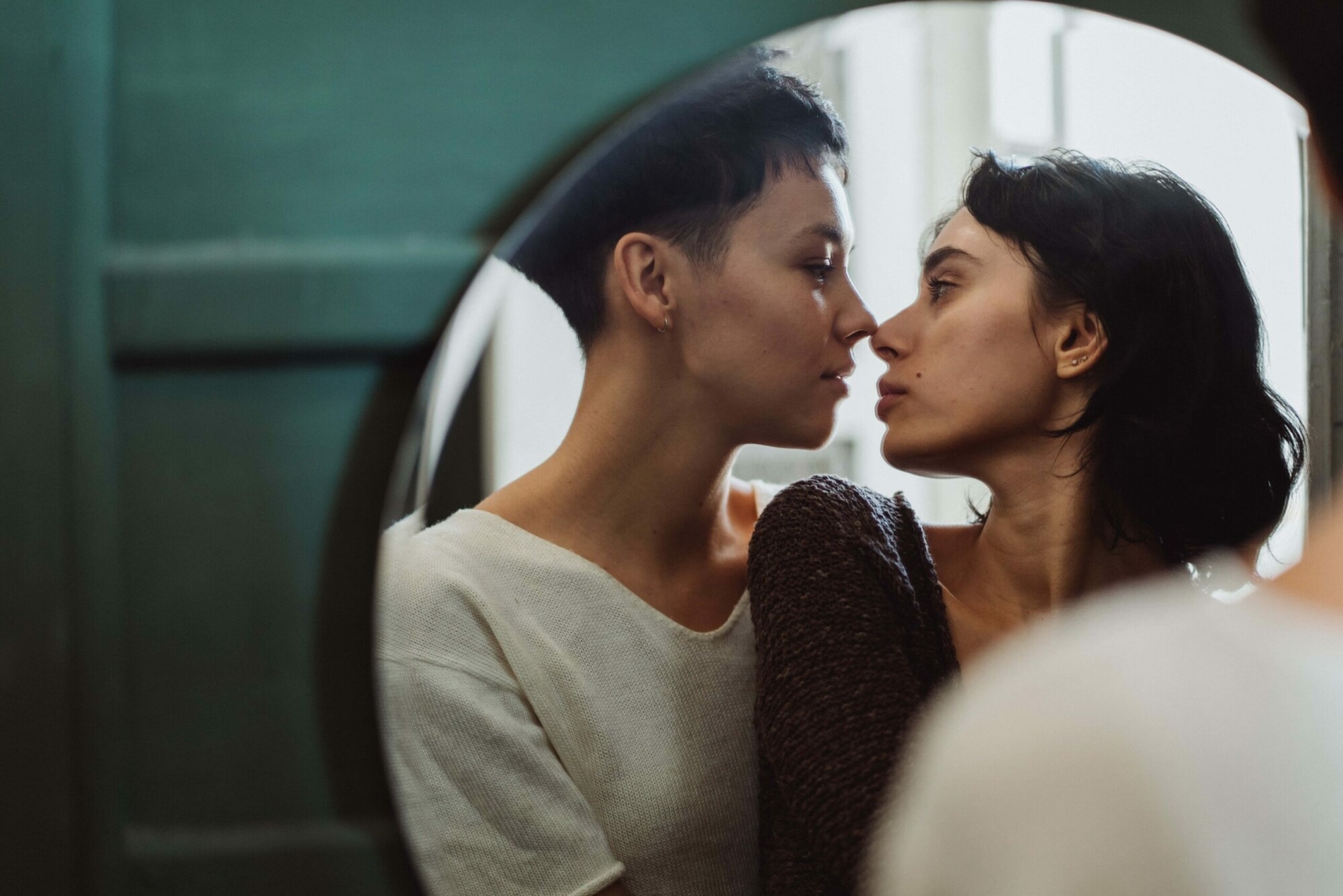 Person looking in mirror, close friends talking, self reflection moment