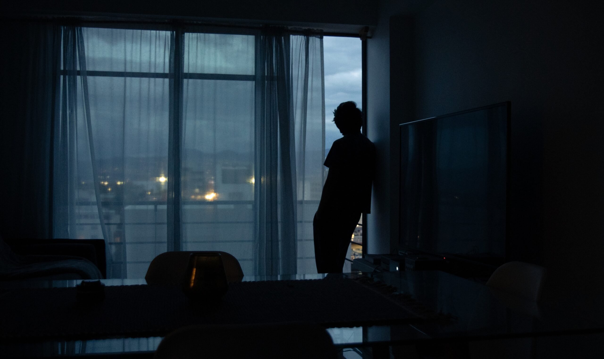 Person looking out window