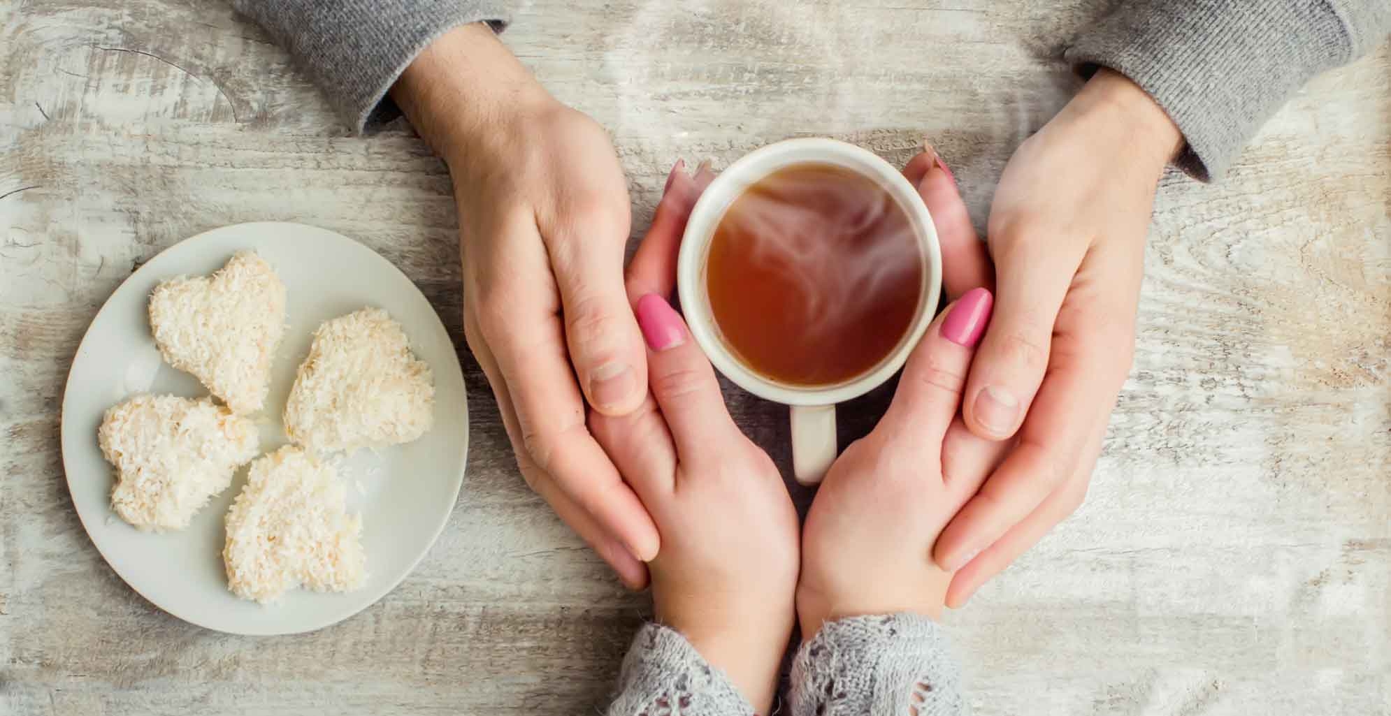 Person offering cup of tea