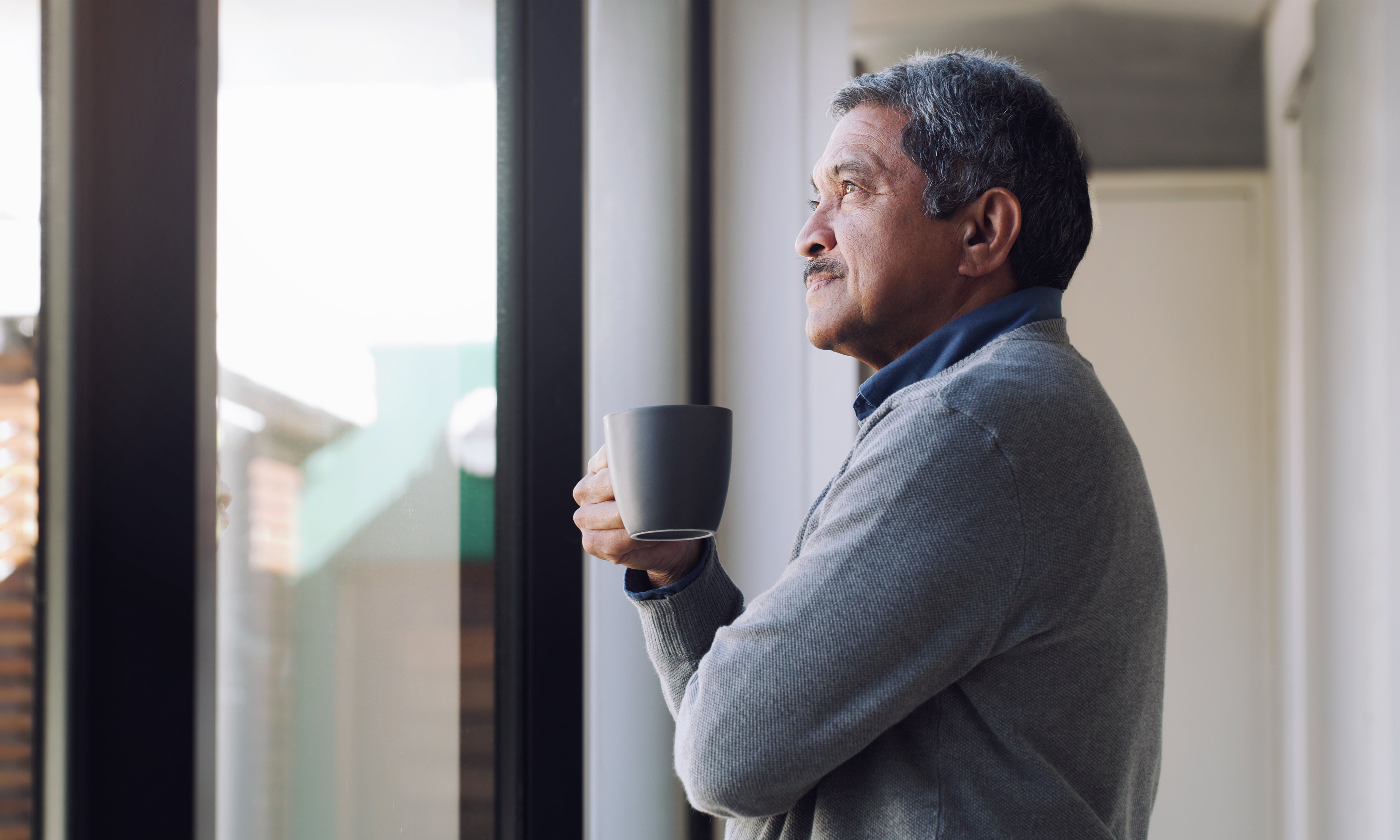 Person reflecting by window, changing direction choice, thoughtful decision