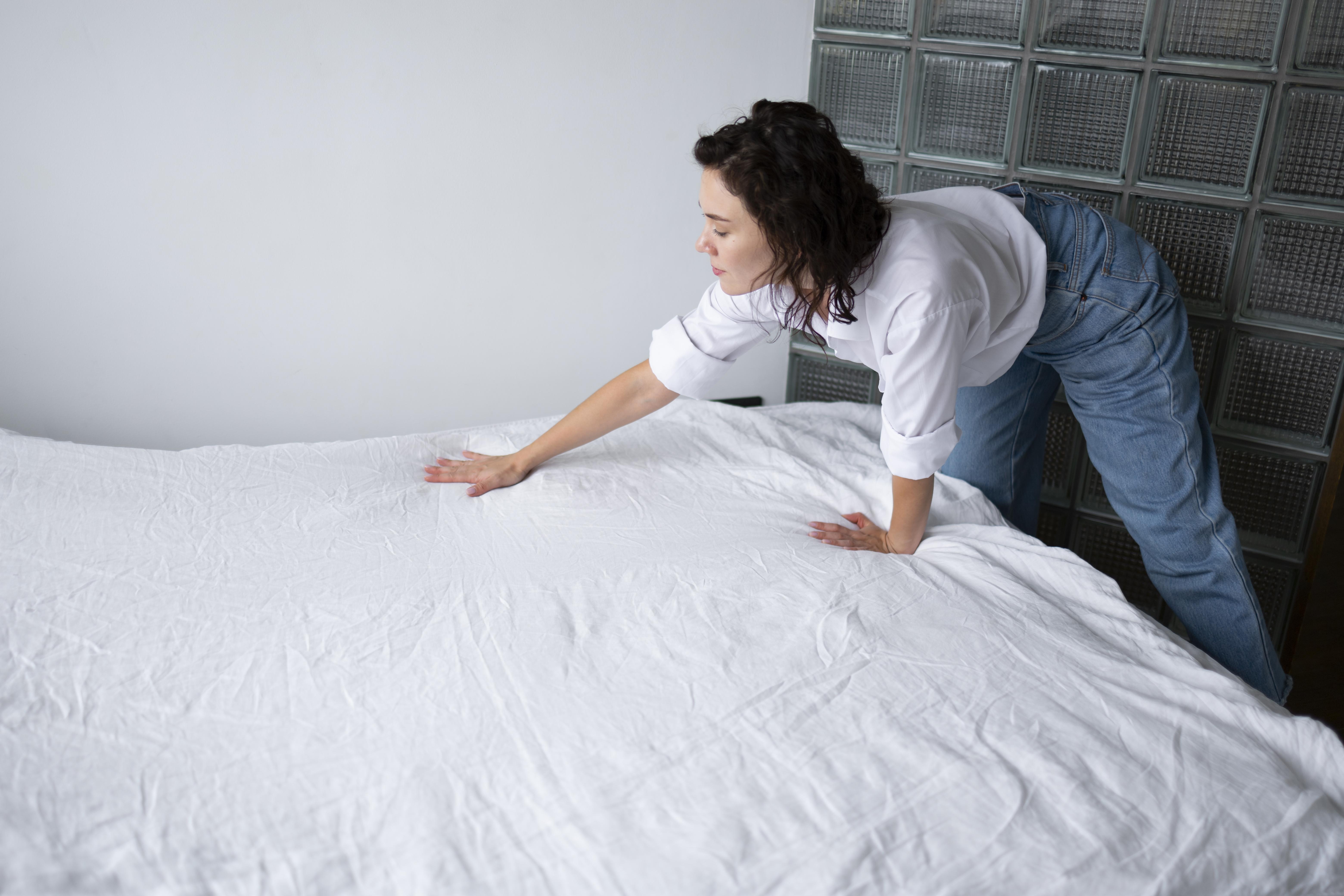 Person tucking in sheets