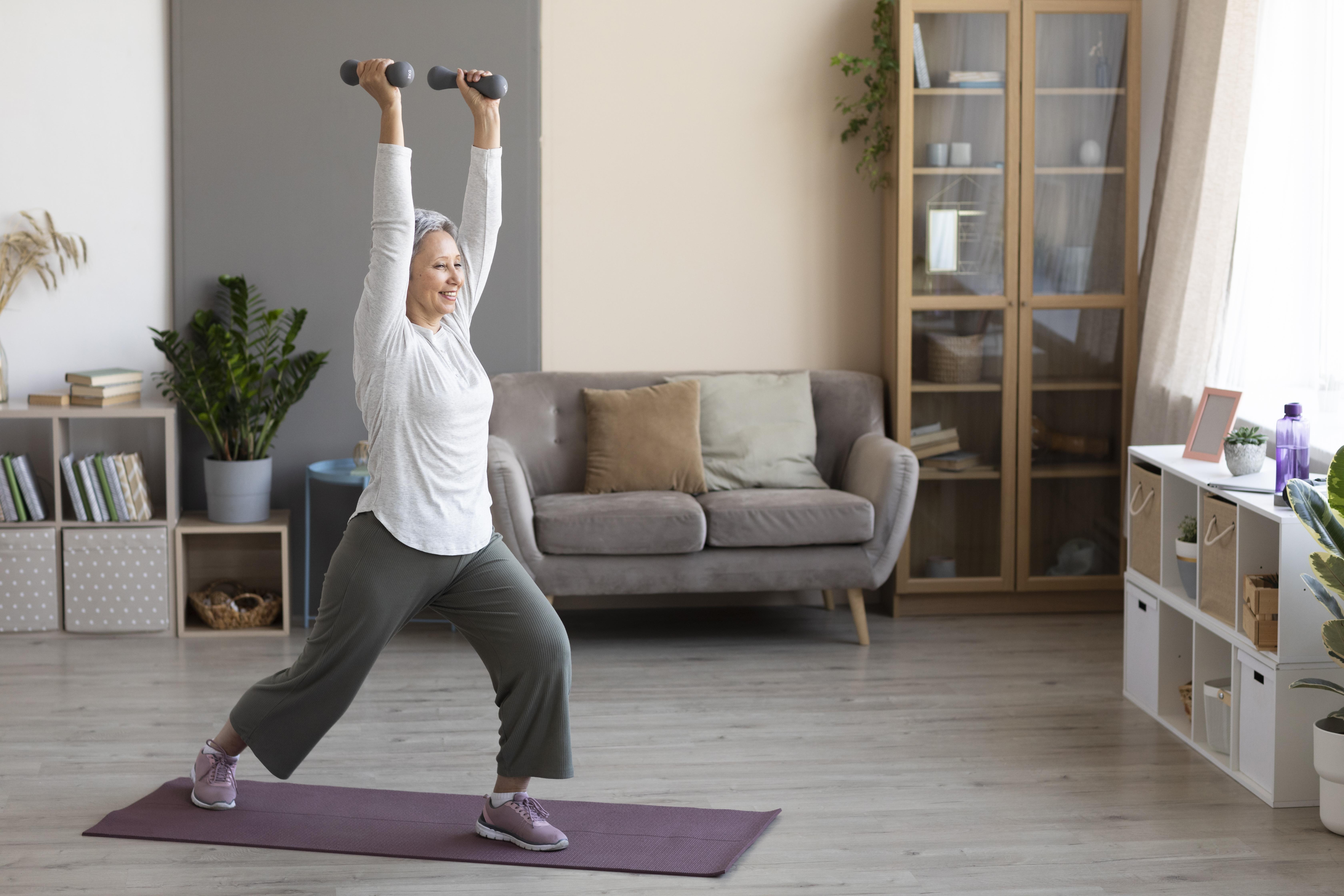 Senior stretching on yoga mat