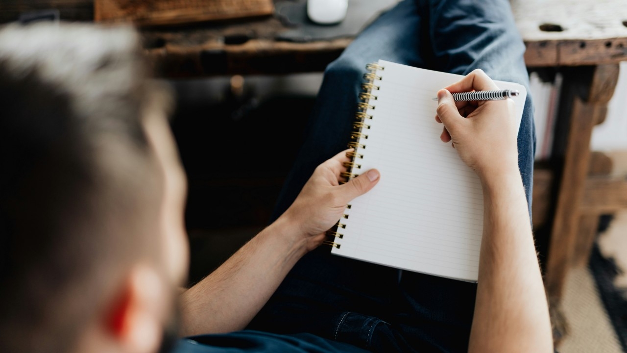 Thoughtful man journaling