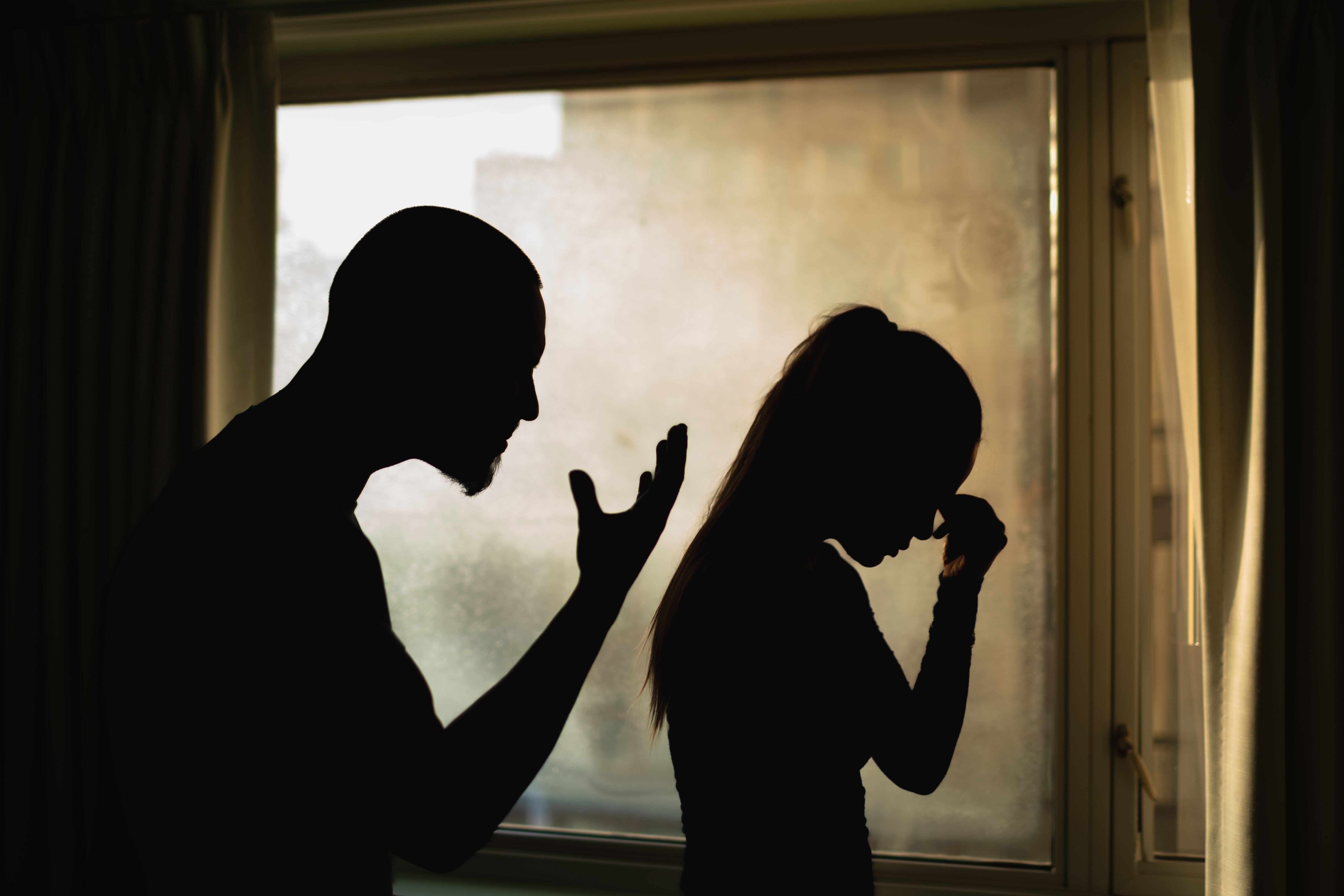 Two people arguing indoors