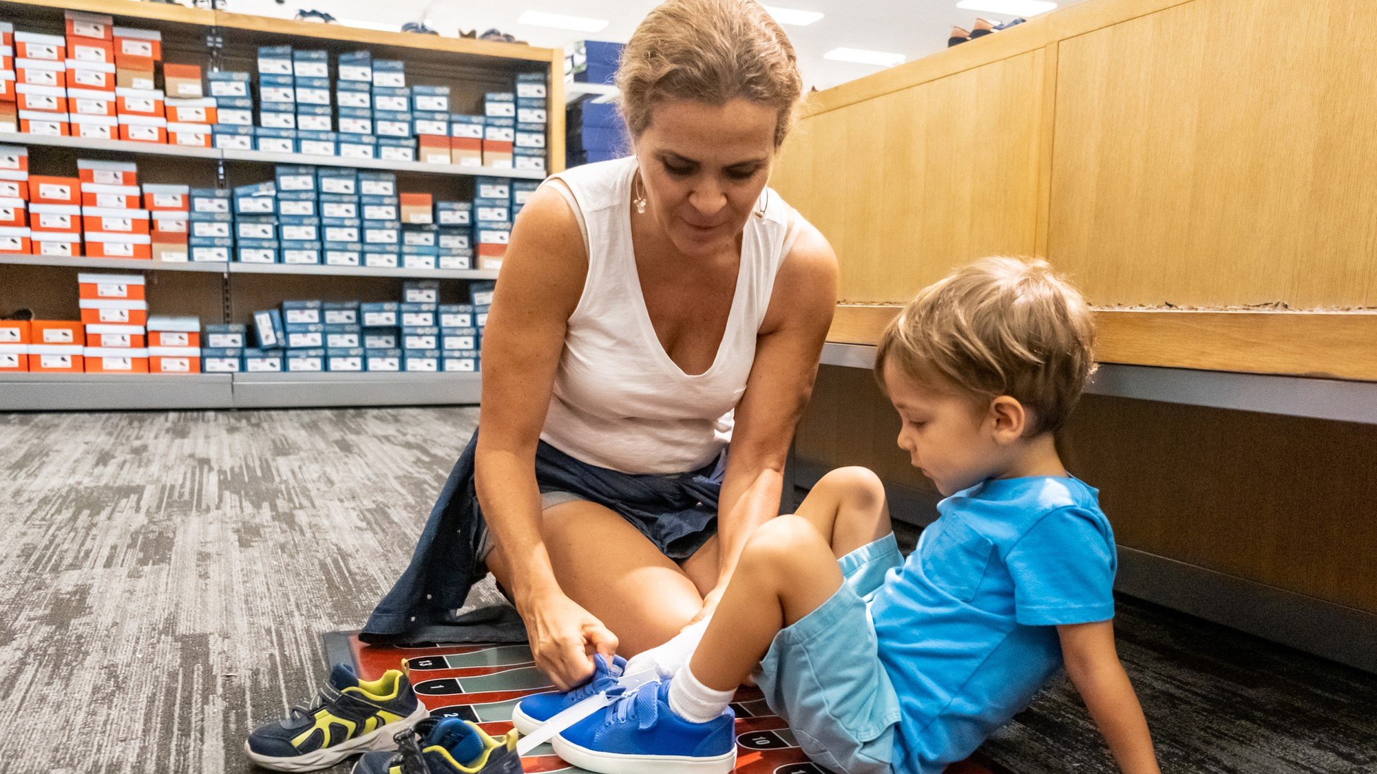Parent tying shoes