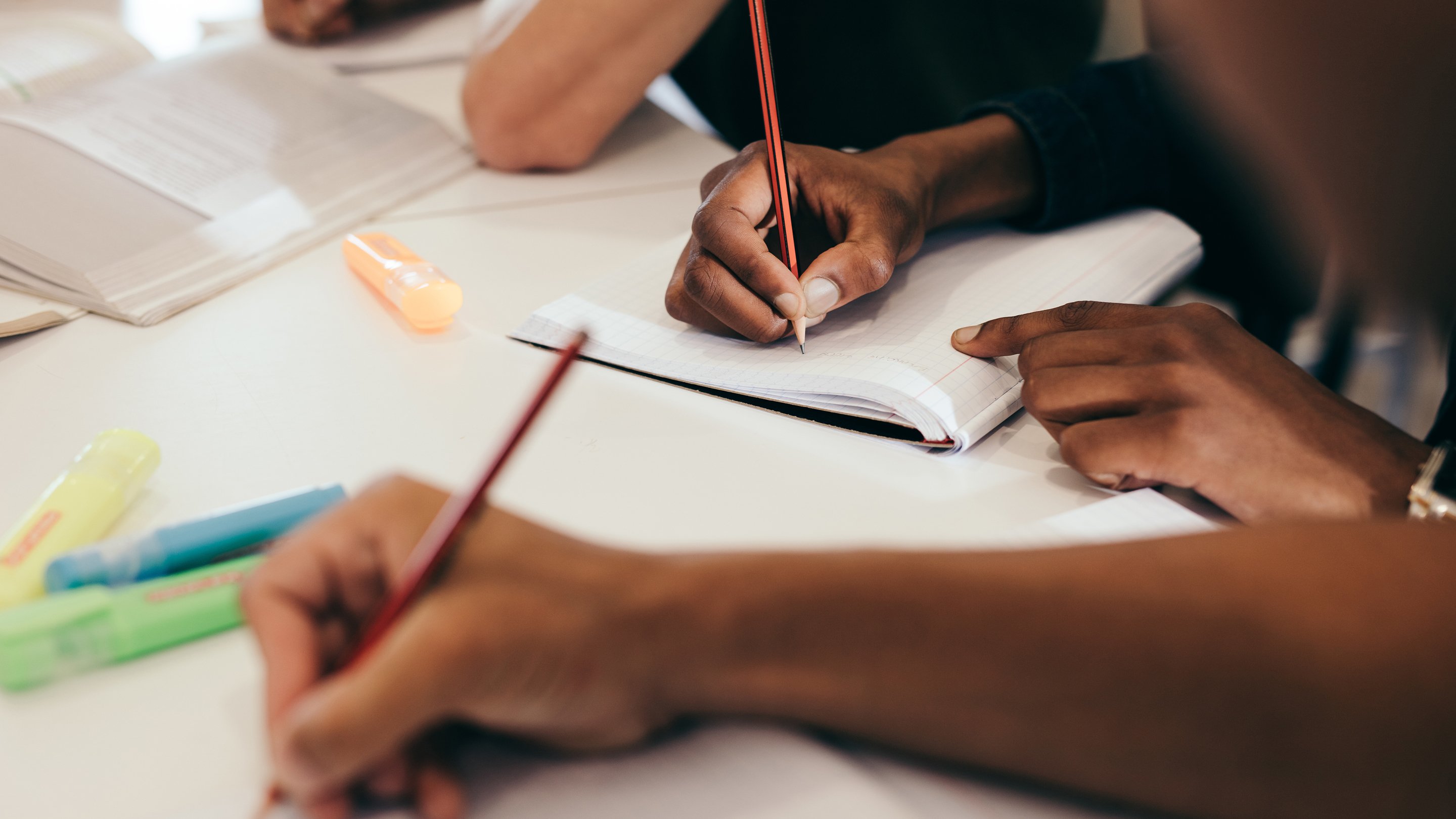 Hands writing notes